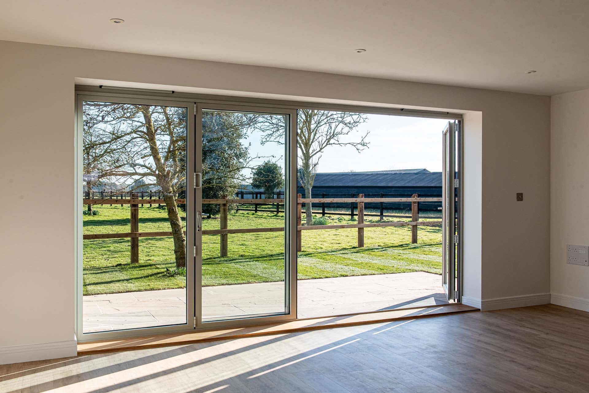 Agate Grey glazing scheme on new-build farmhouse with oak accents and dark weatherboarding