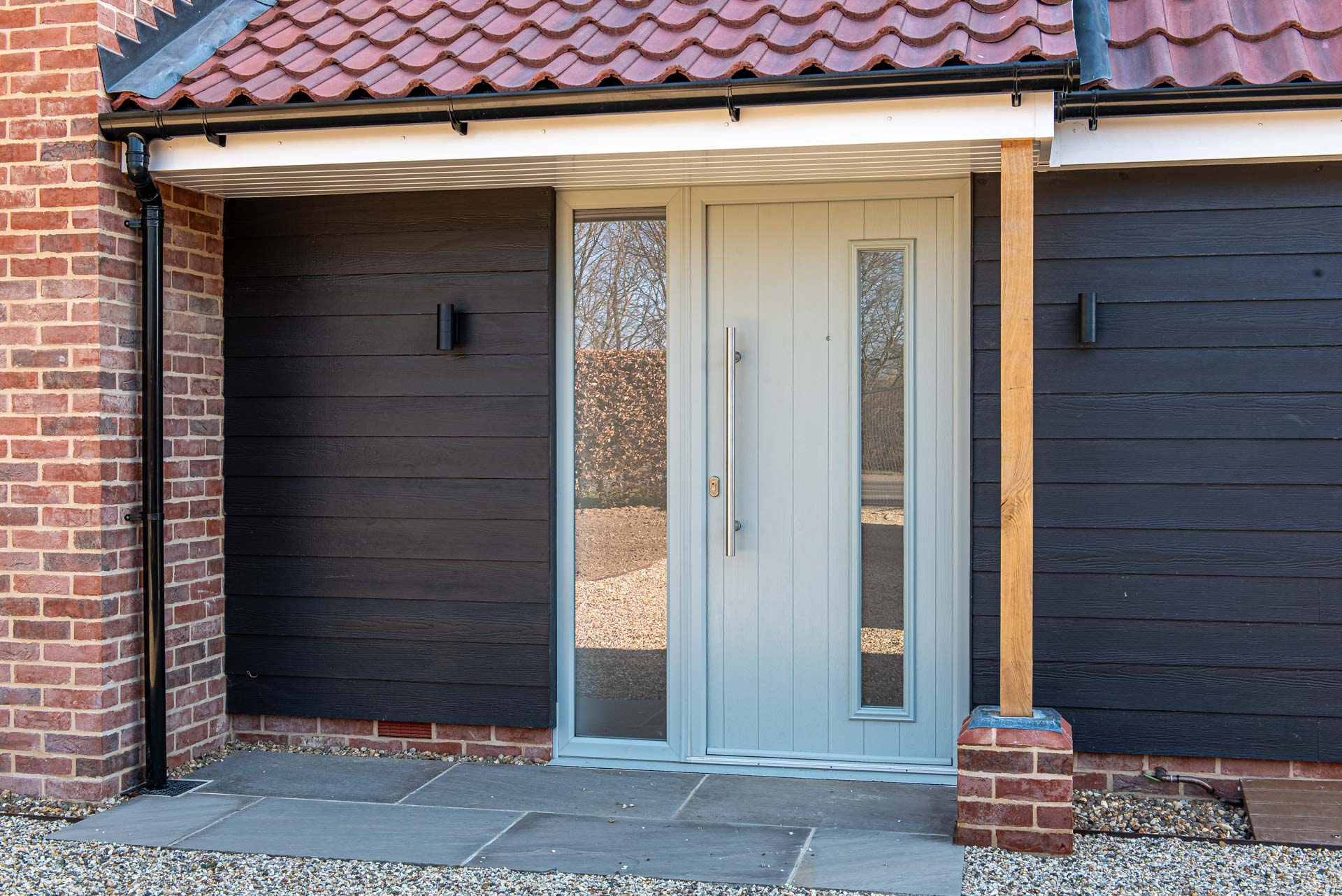 Half-glazed Solidor composite back door in Agate Grey on farmhouse rear elevation