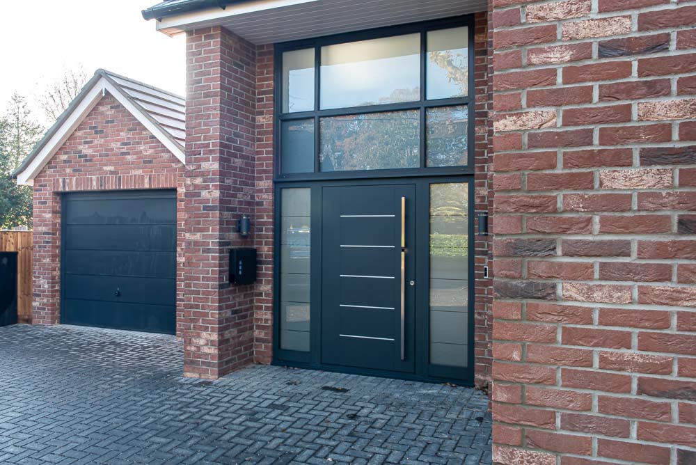Anthracite Spitfire aluminium entrance door with a full-height glazed sidelight