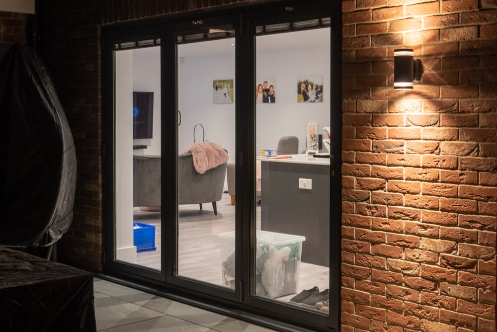 Aluminium bi-folding doors open to the garden from the kitchen-diner