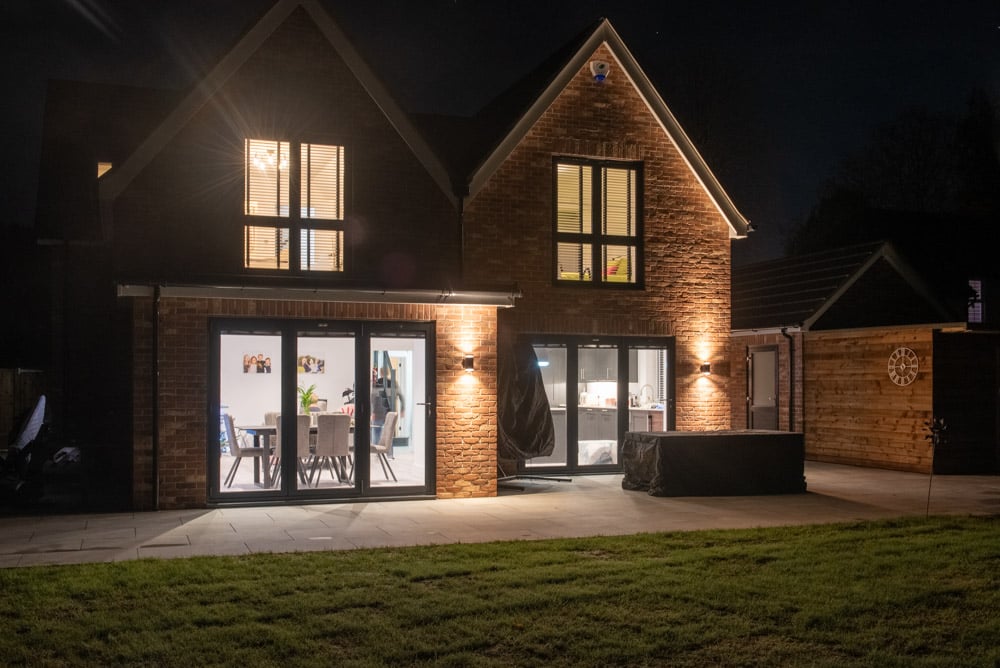 Rear bedroom with full-height flush sash glazing and garden views