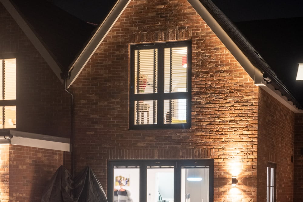 Full-height flush sash windows providing panoramic views from a rear bedroom