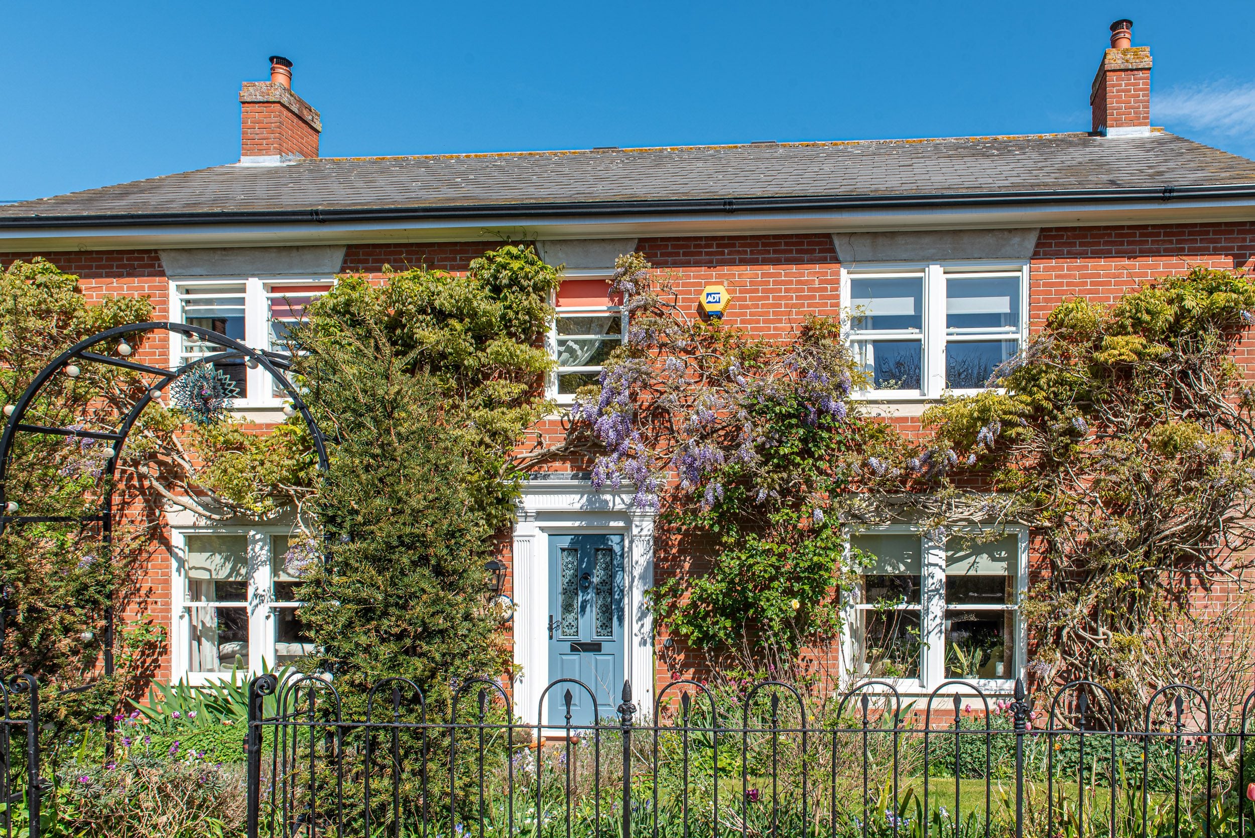 Red brick home with blue Solidor front door, Windows Etc Essex