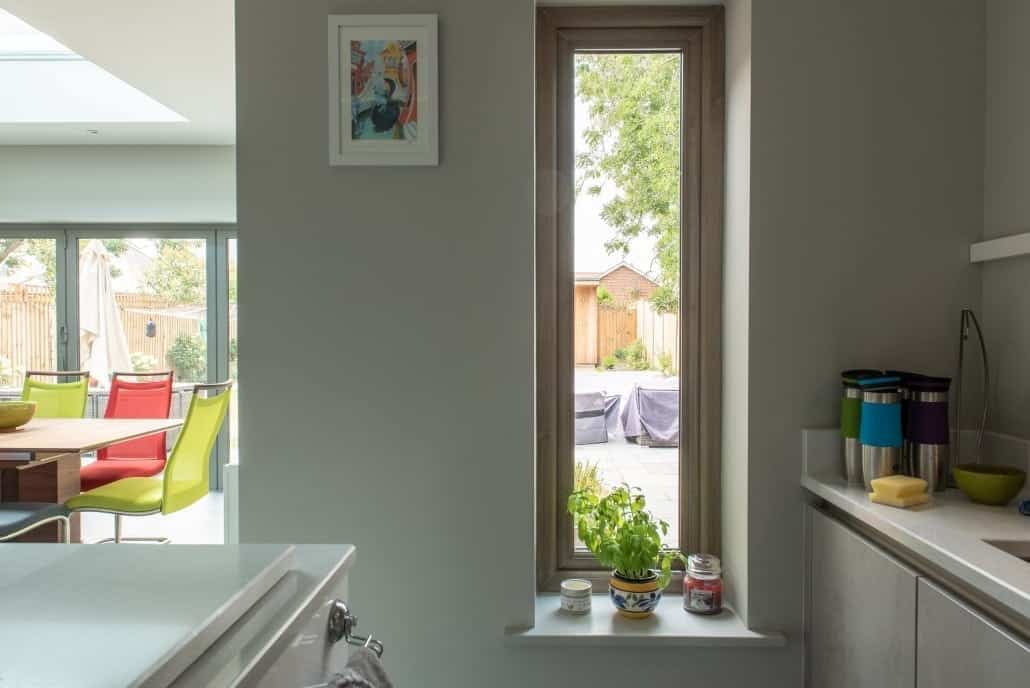 Front bay windows in uPVC woodgrain finish against local stock brickwork