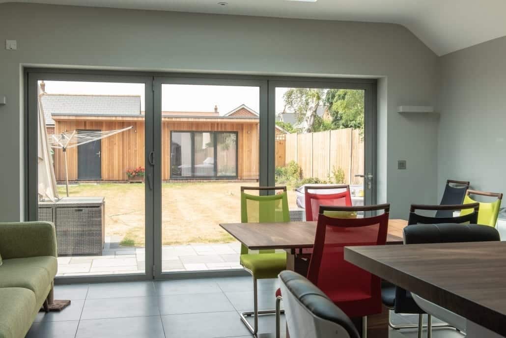 Self-build home exterior with uPVC windows, Solidor composite front door and oak beam porch detail