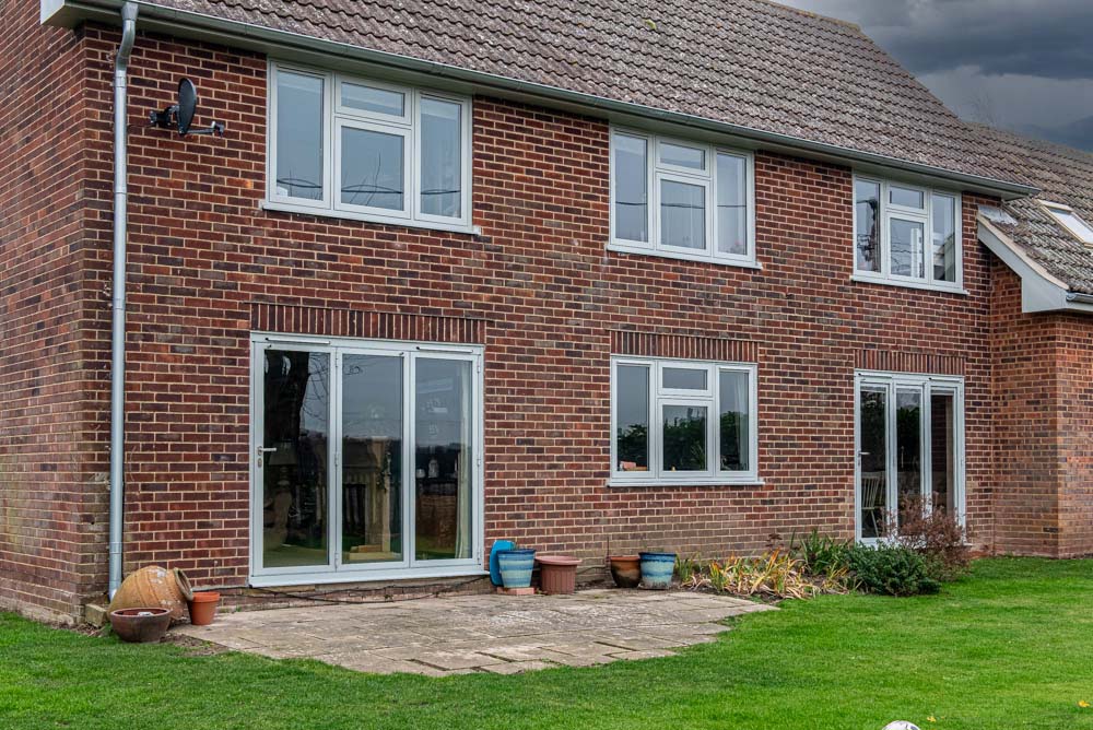 Red brick home with white flush casement windows, Windows Etc Essex