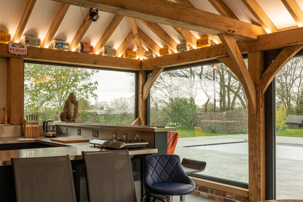 Exterior view of pool house aluminium glazing with green oak framing