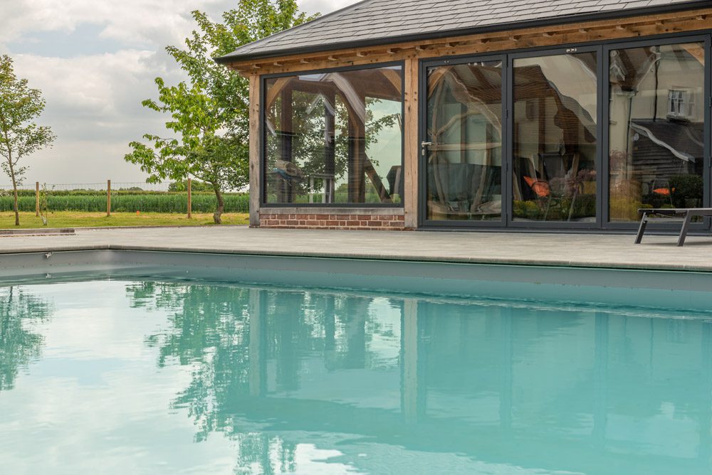 Pool house glazing, aluminium bifolds folded to one side