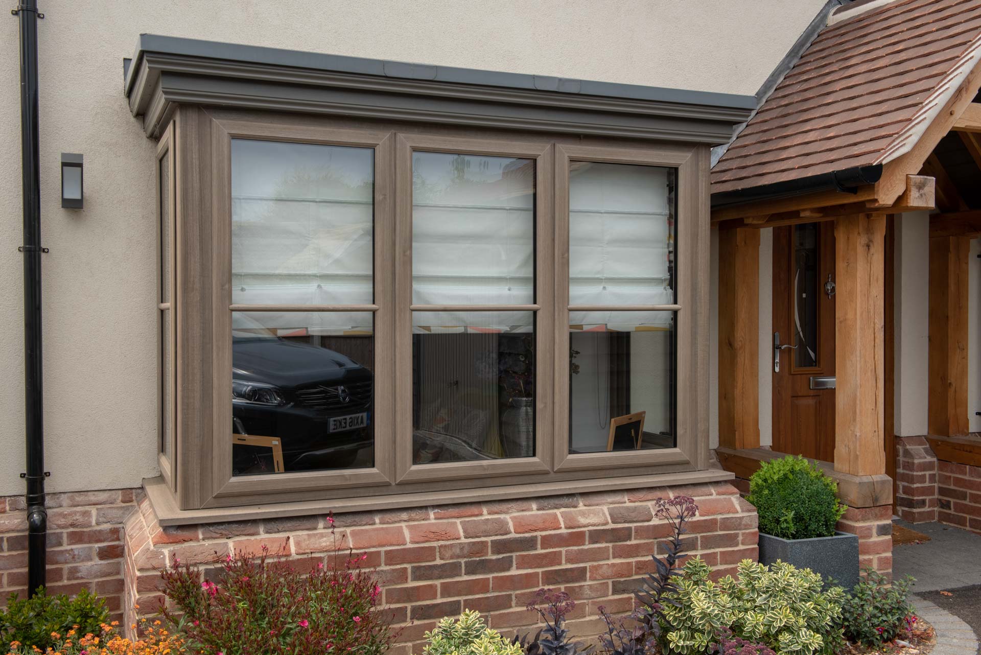 Grey bay casement window beside oak porch, North Colchester Essex