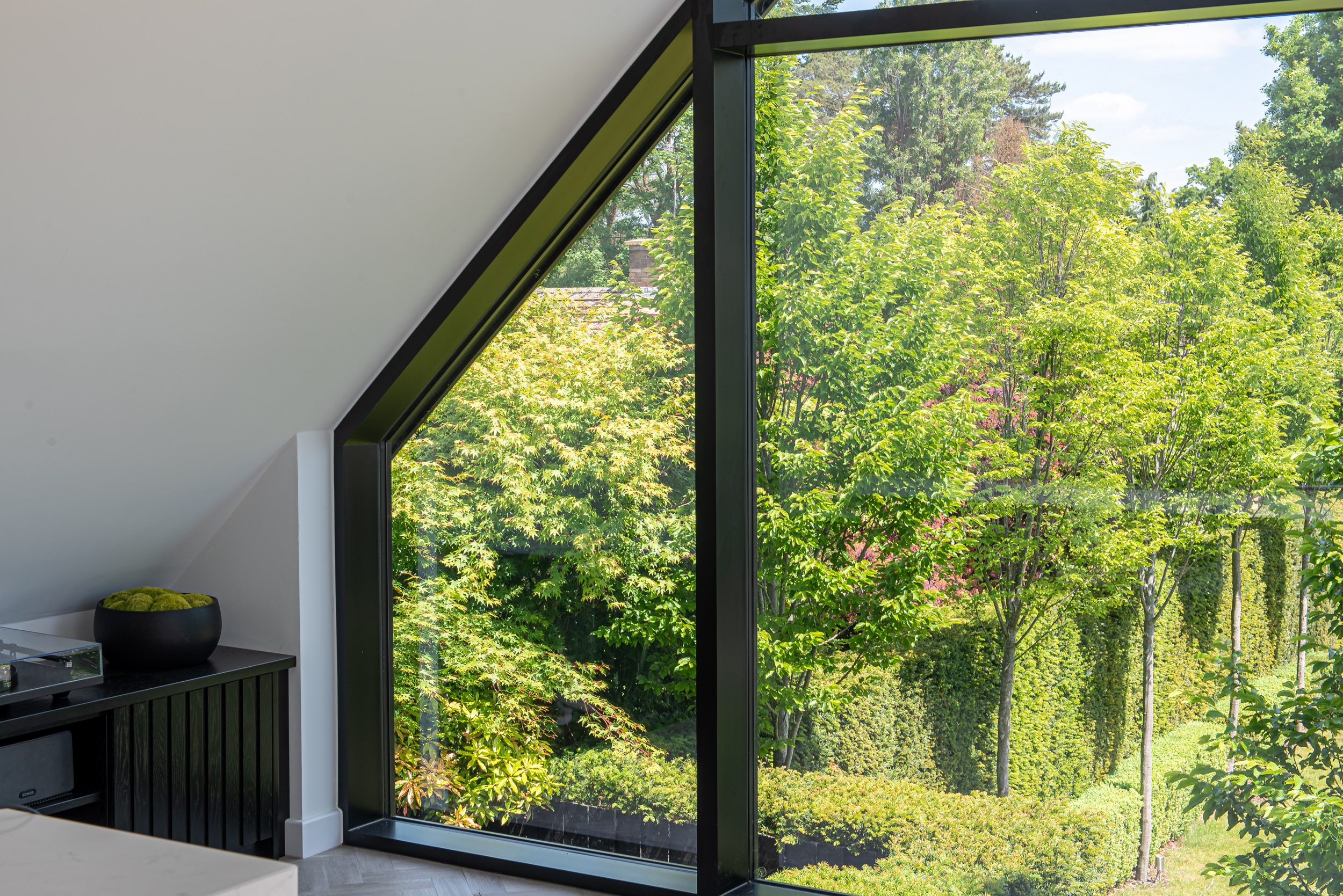 Aluminium lift and slide doors open to garden on converted gymnasium