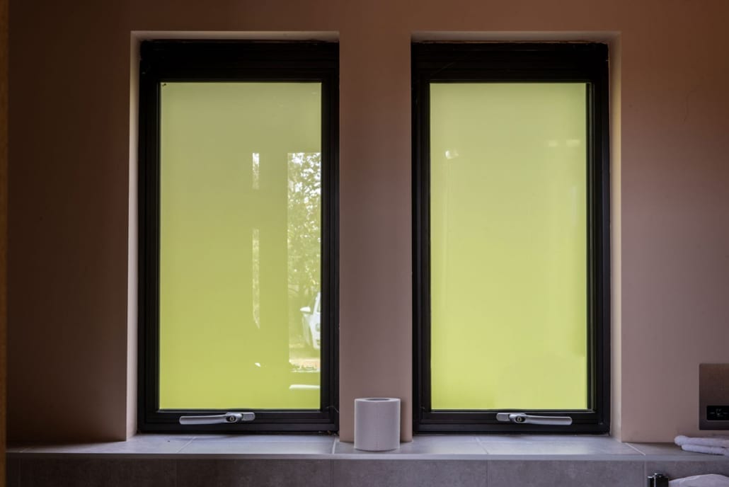 aïr lift-and-glide sliding doors open onto barn conversion exterior, dark aluminium frame