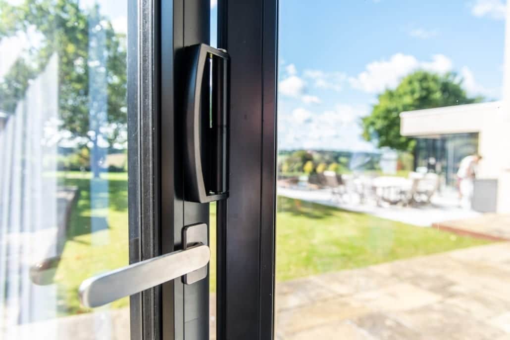 Garden elevation of the modern extension with aïr bifold doors swept back