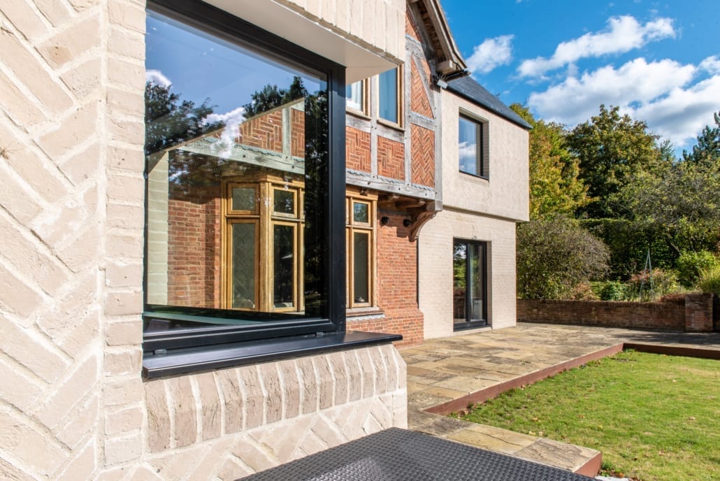 Smarts Heritage aluminium windows on a mixed-period brick extension with indoor-outdoor living