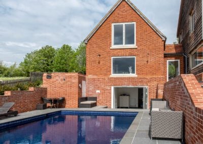 Red brick home with pool and Smarts aluminium windows, Essex
