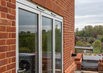Smarts aluminium bifold doors opening to pool terrace on rural Suffolk property