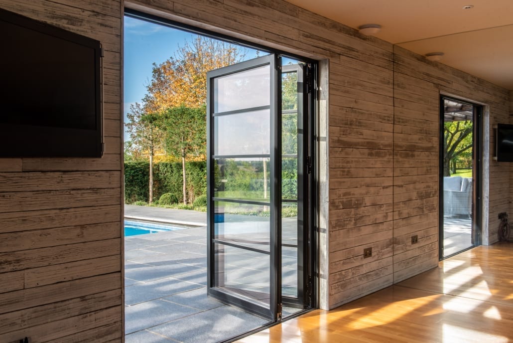 Smarts Heritage 47 aluminium windows on a pool house with scorched timber cladding