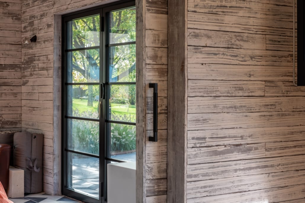 aïr bifold doors folded back opening pool house gym to the outdoor pool area