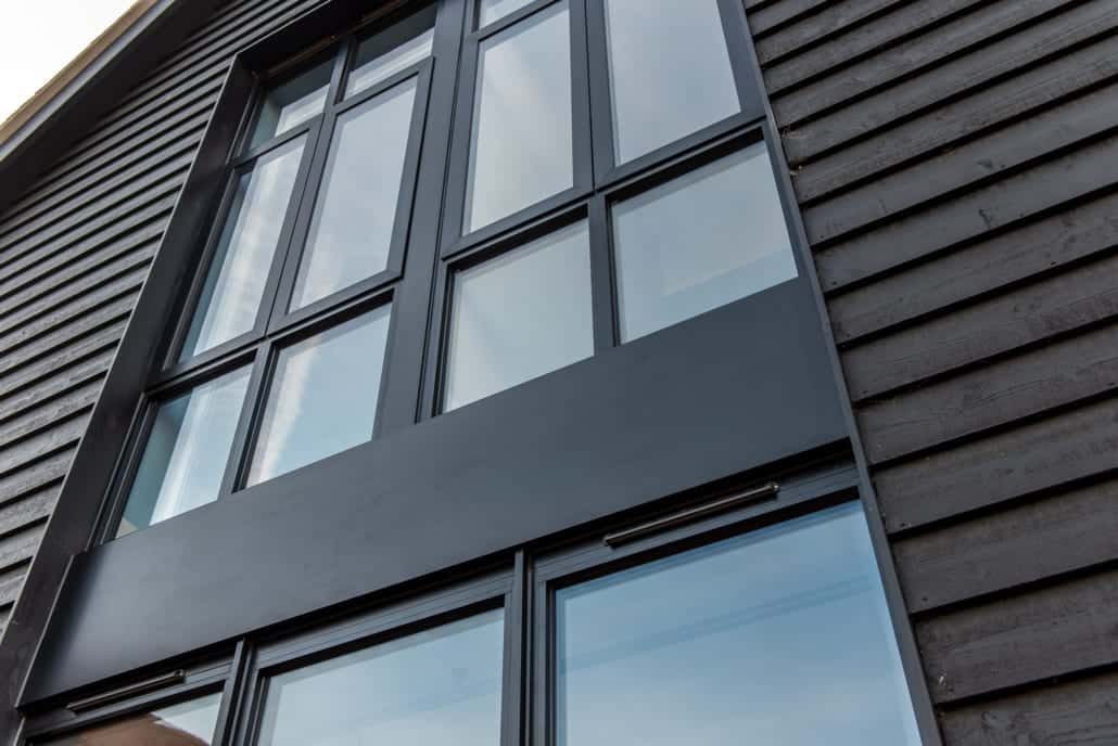 Smarts bifolds open to decking on Essex barn, seamless indoor-outdoor transition