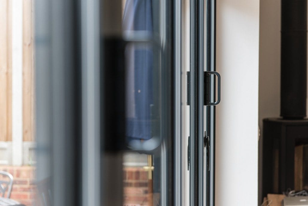 Leaded light bay window with monkey tail handles on coastal property