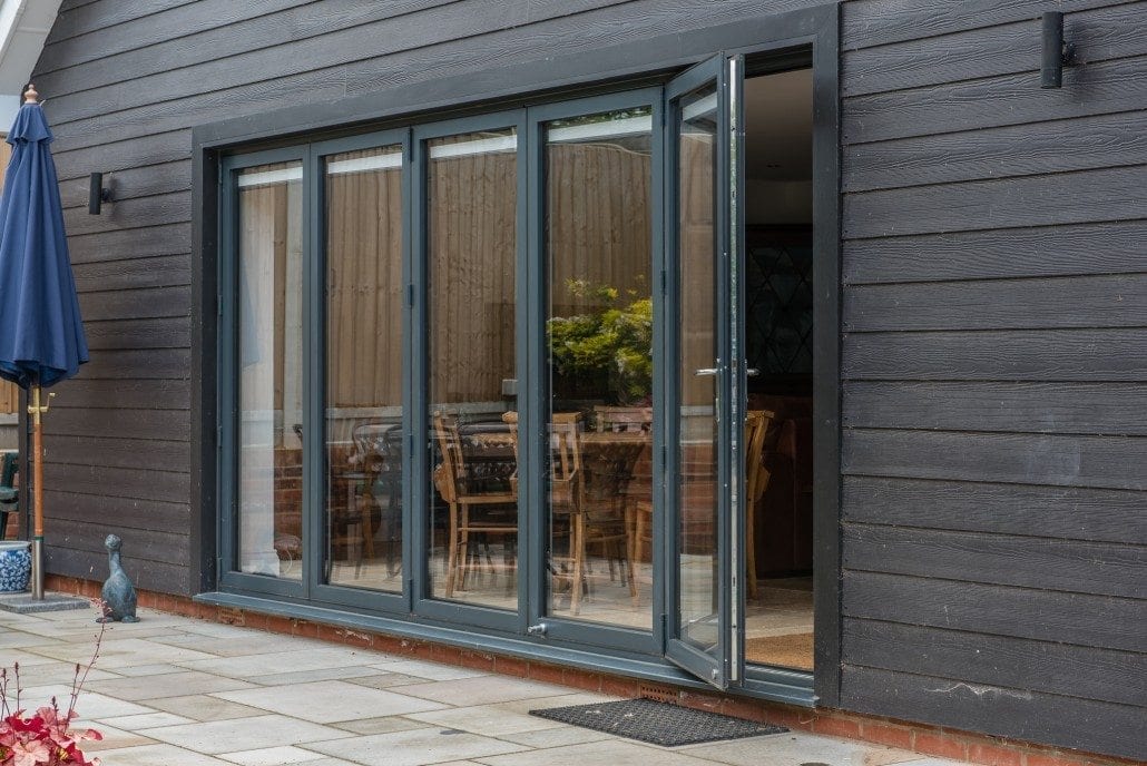 Half-glazed aluminium bifold doors on garage at coastal chalet