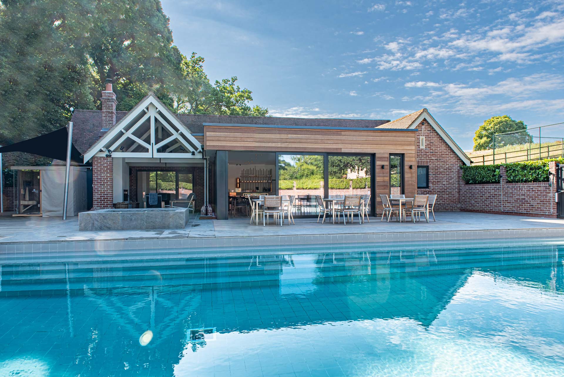Exterior view of Maison Talbooth Hotel spa building with anthracite glazing and cedar cladding
