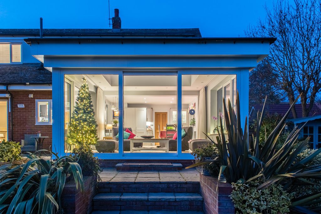 Open-plan living area with floor-to-ceiling sliding doors and natural light