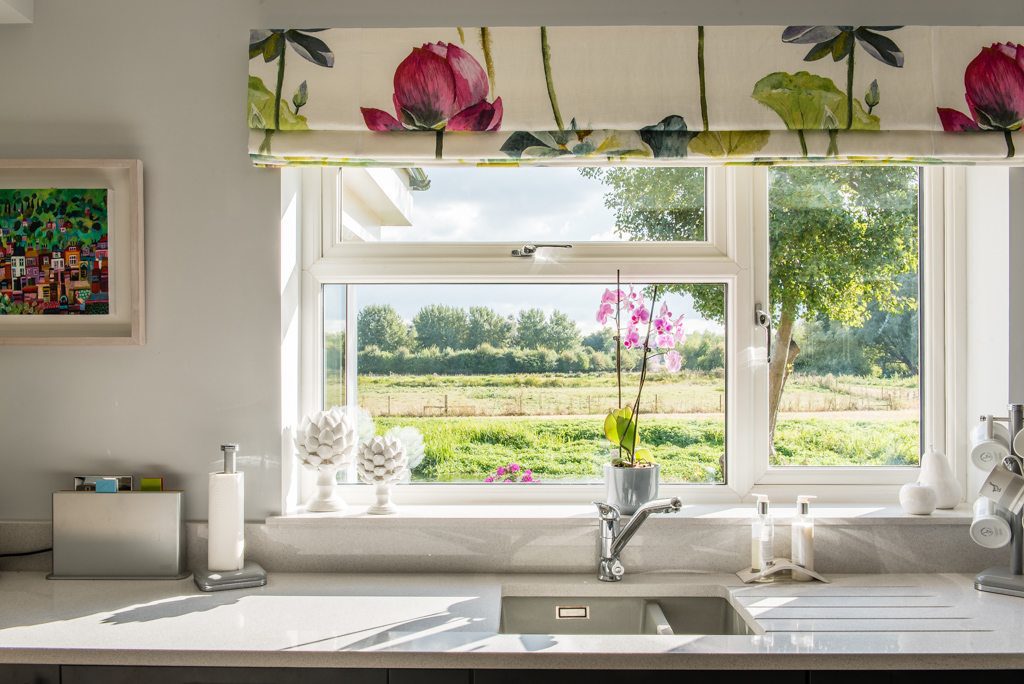 Open sliding doors on a south-facing extension with river views
