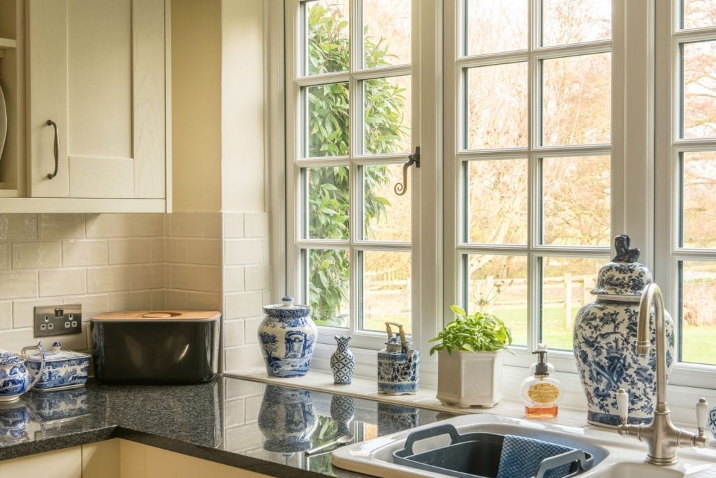 Traditional uPVC stormproof casement window with timber-effect finish on a rural Essex property