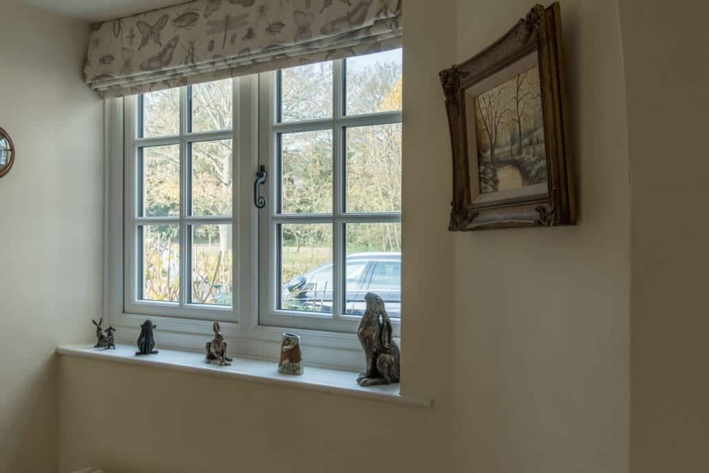uPVC windows in traditional profiles on a clay peg tile and red-brick English country home