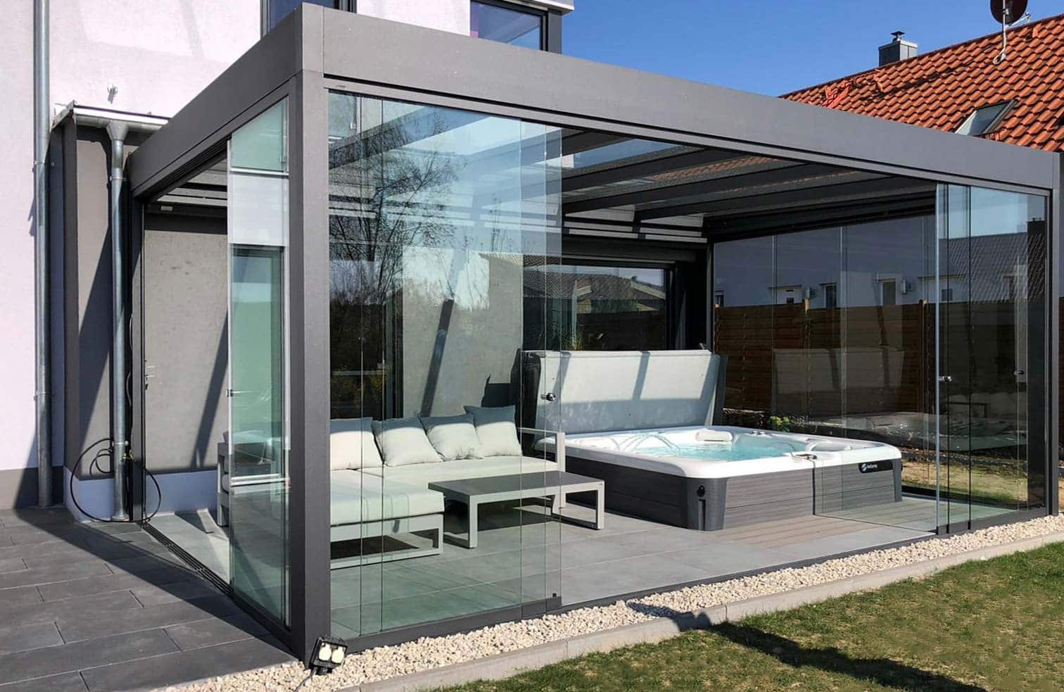 Sunparadise CUBO glass room with lounge seating and a hot tub