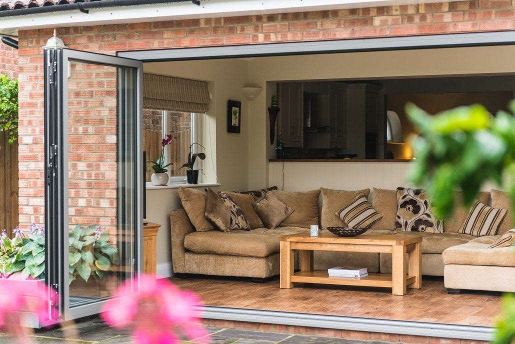 Aluminium bifold doors folded back onto a living room