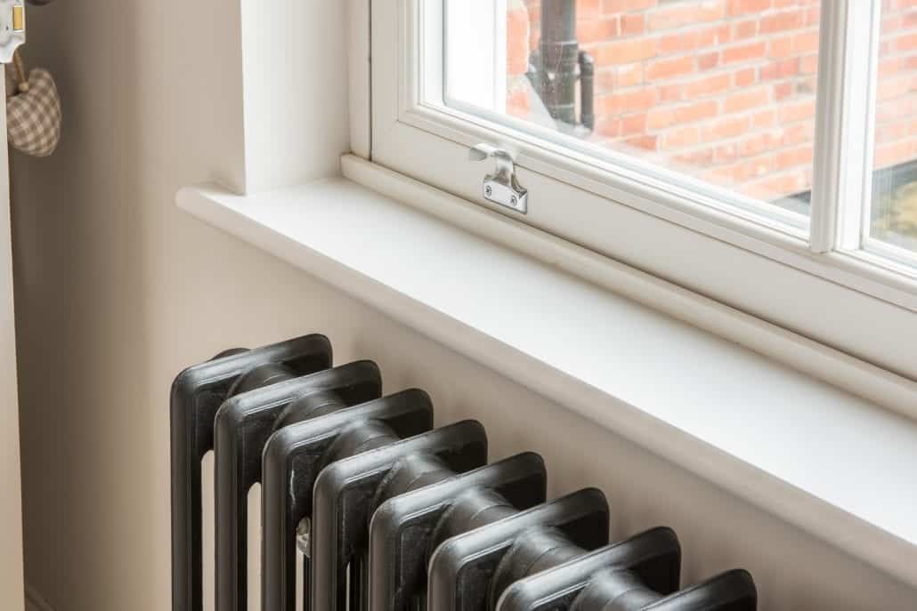 White Roseview sash window above a cast-iron radiator