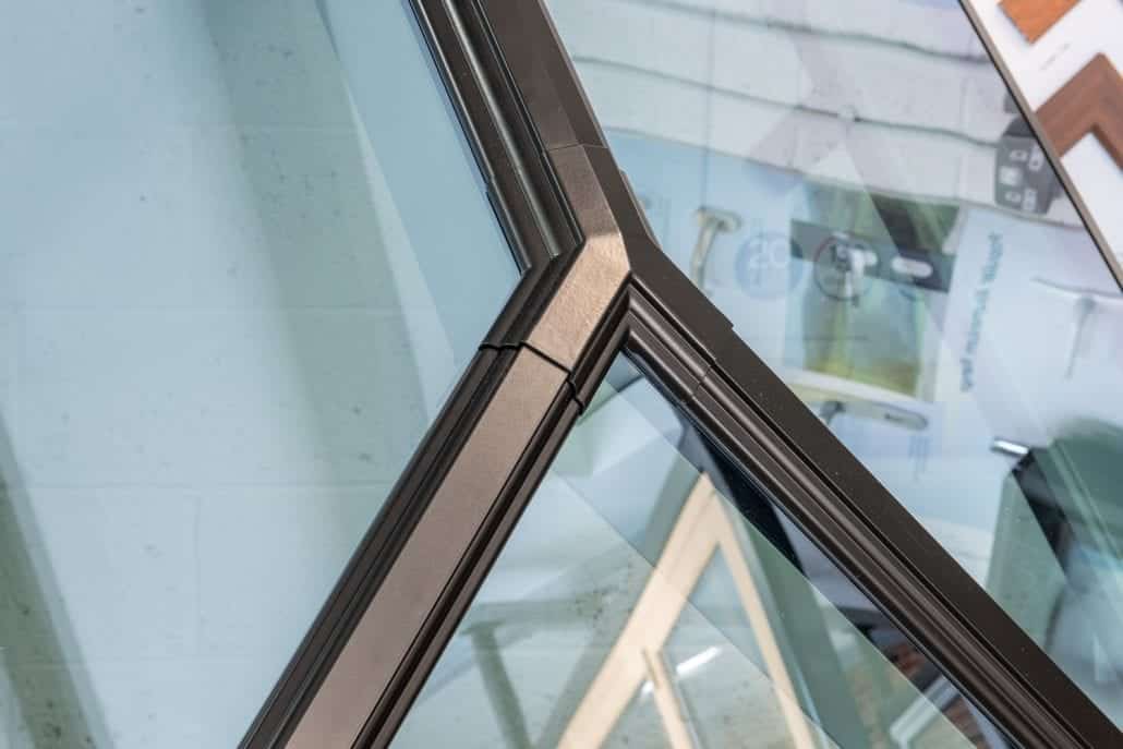 Close-up of Korniche lantern glazing meeting at a bronze rafter bar