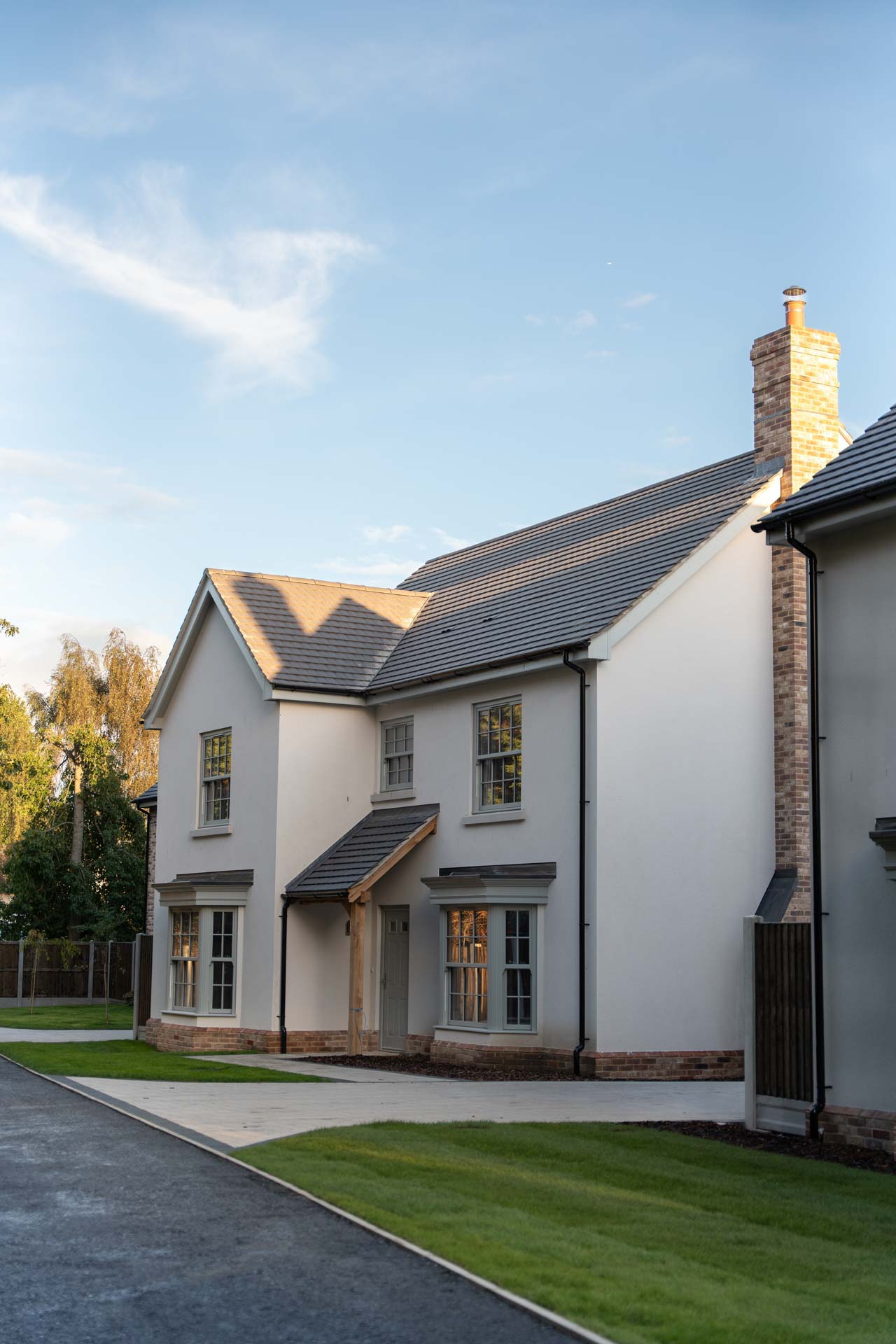 Side view along the rendered homes at Malting Paddocks showing the uPVC vertical sliding windows