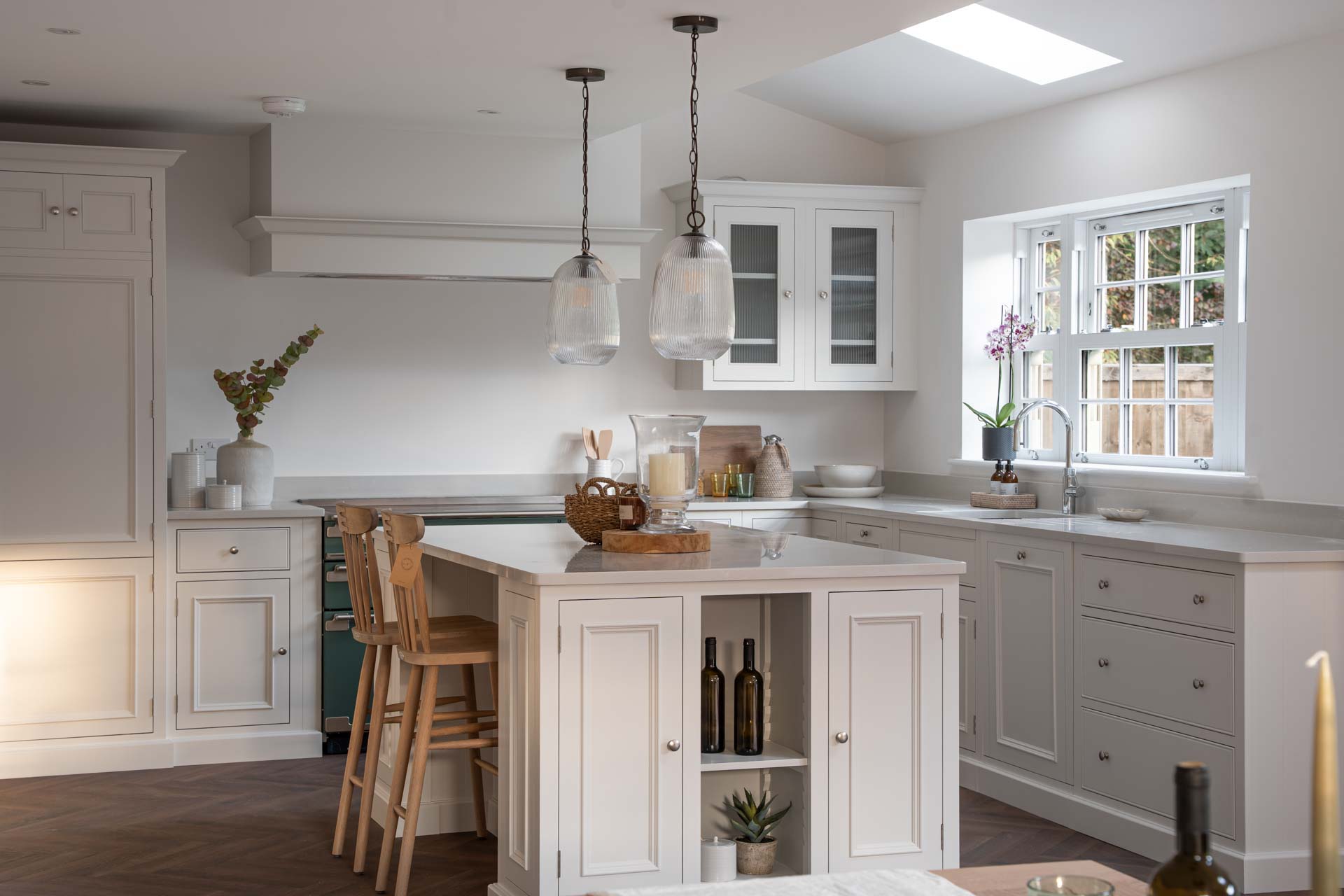 Shaker kitchen with a white uPVC vertical sliding window above the sink