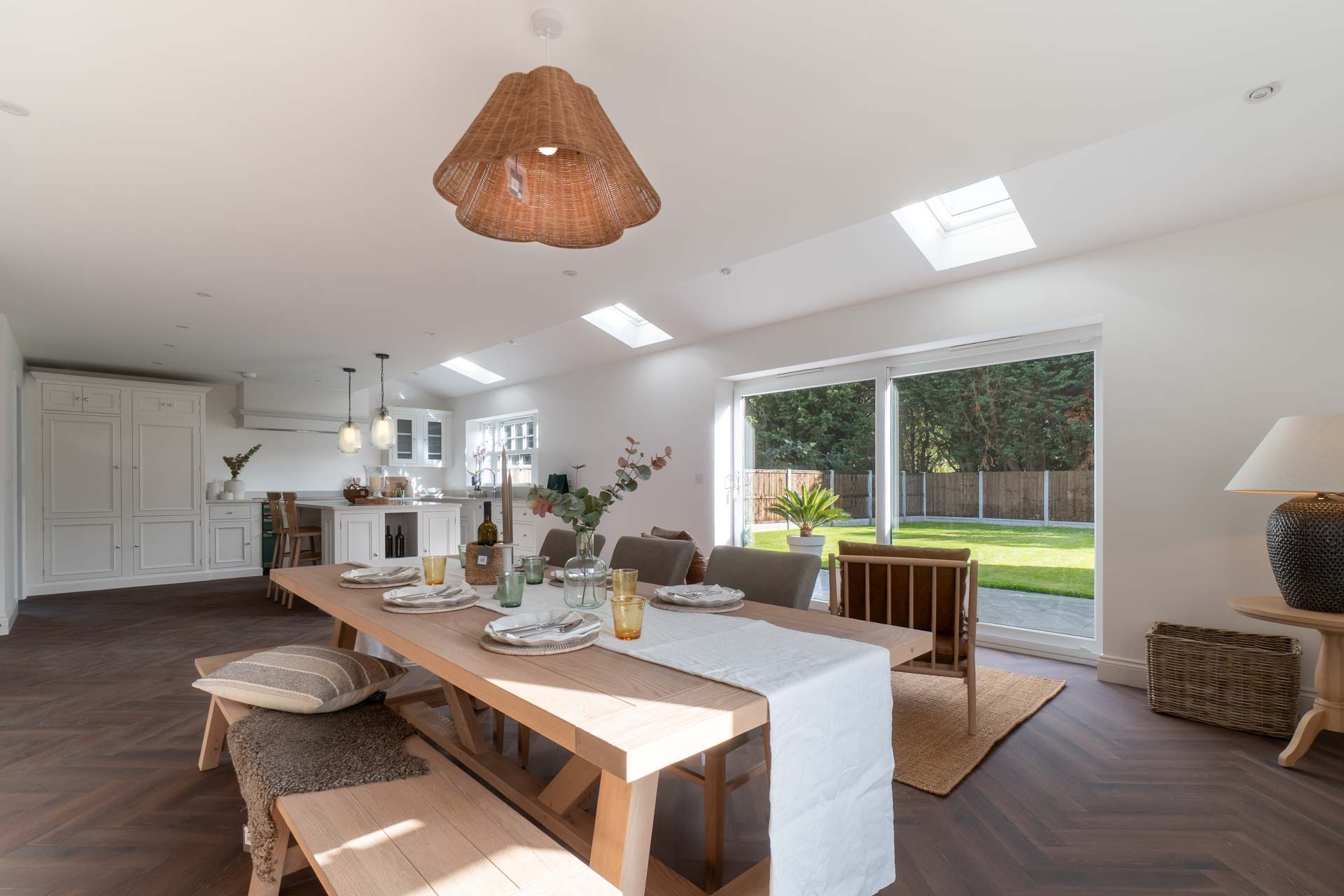 Open-plan kitchen and dining room with white uPVC sliding patio doors onto the garden