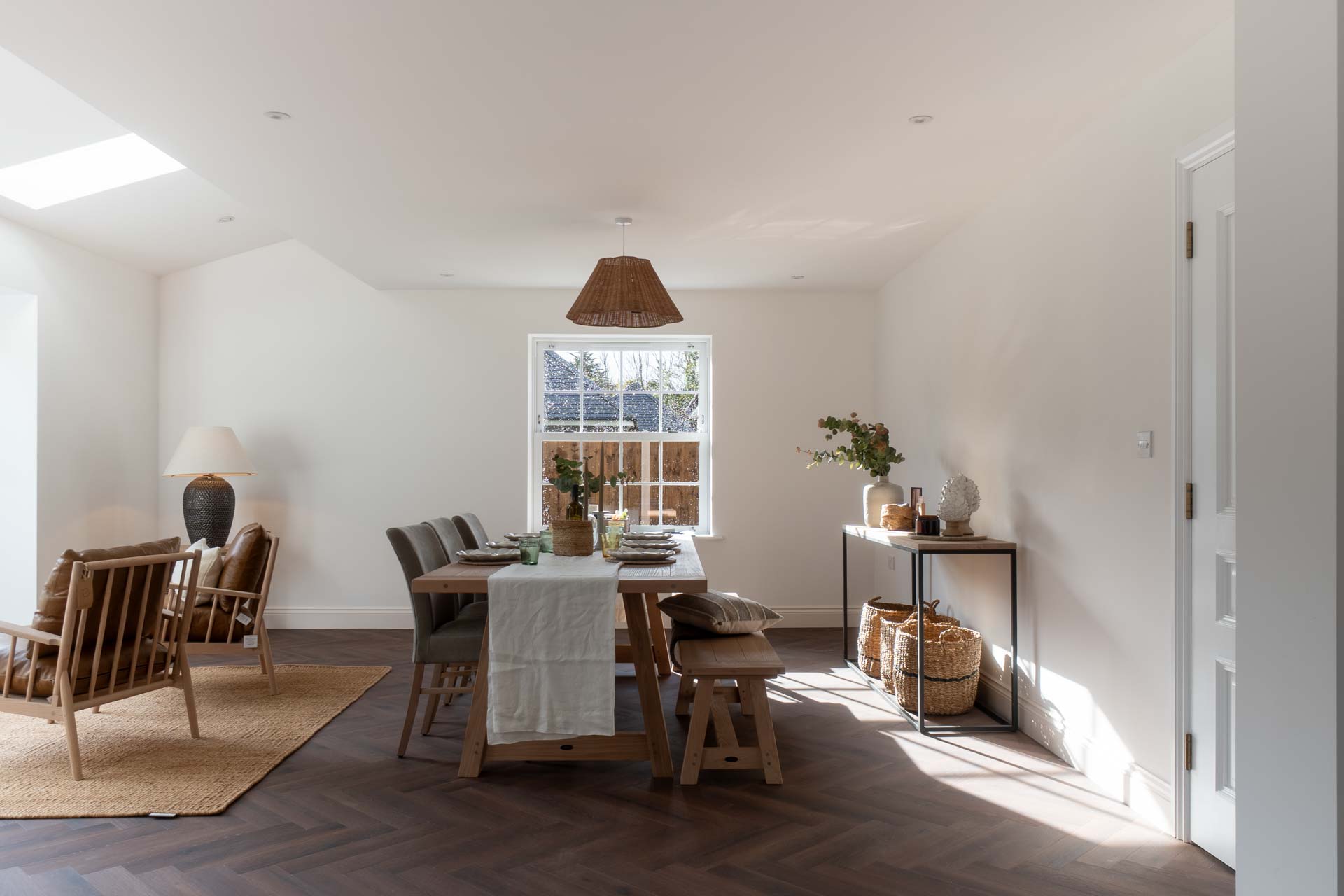 Dining room with a white uPVC vertical sliding window overlooking the garden