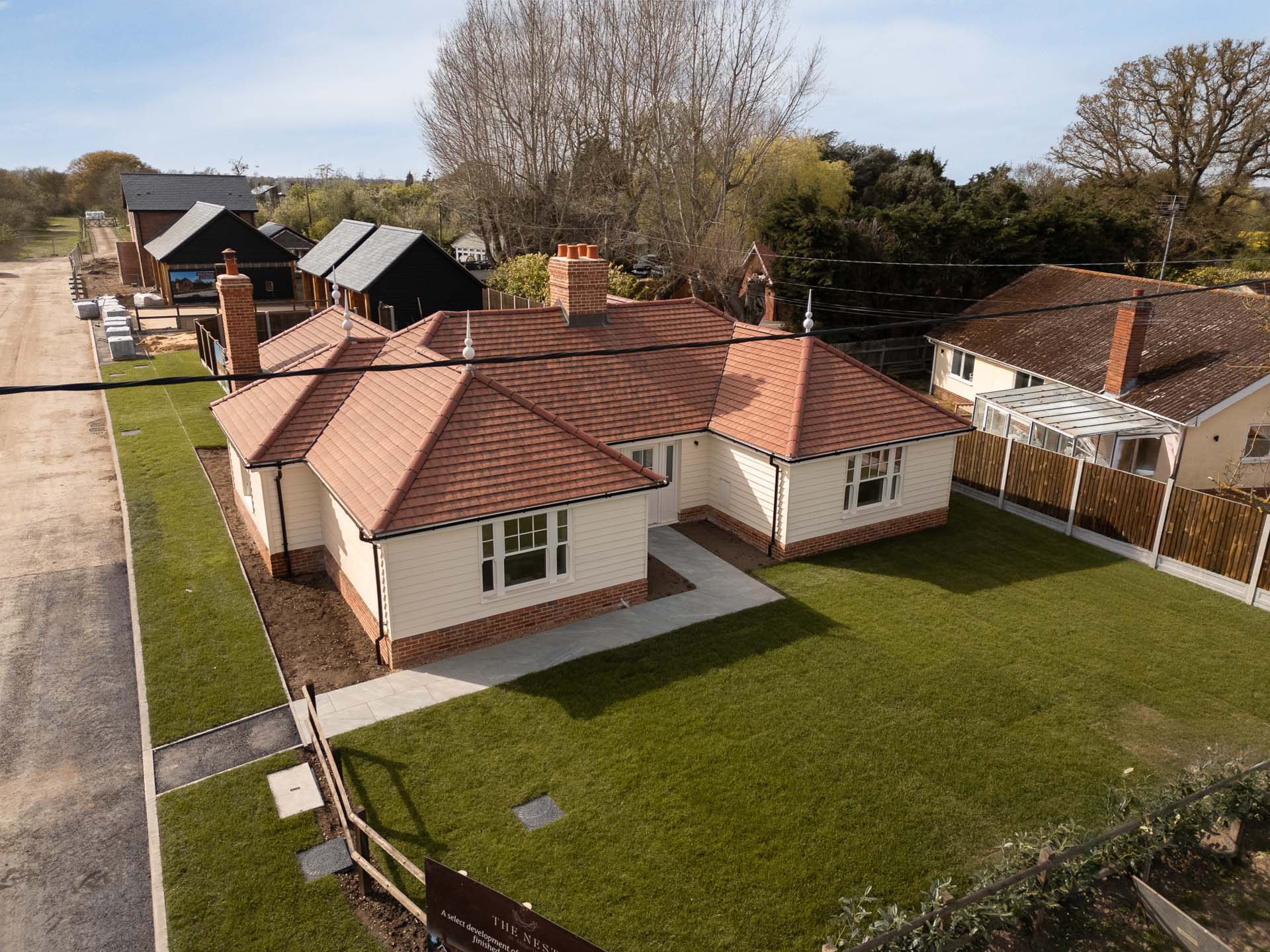 Aerial view of a single-storey home at The Nest showing the vertical sliding windows and French doors across the rear