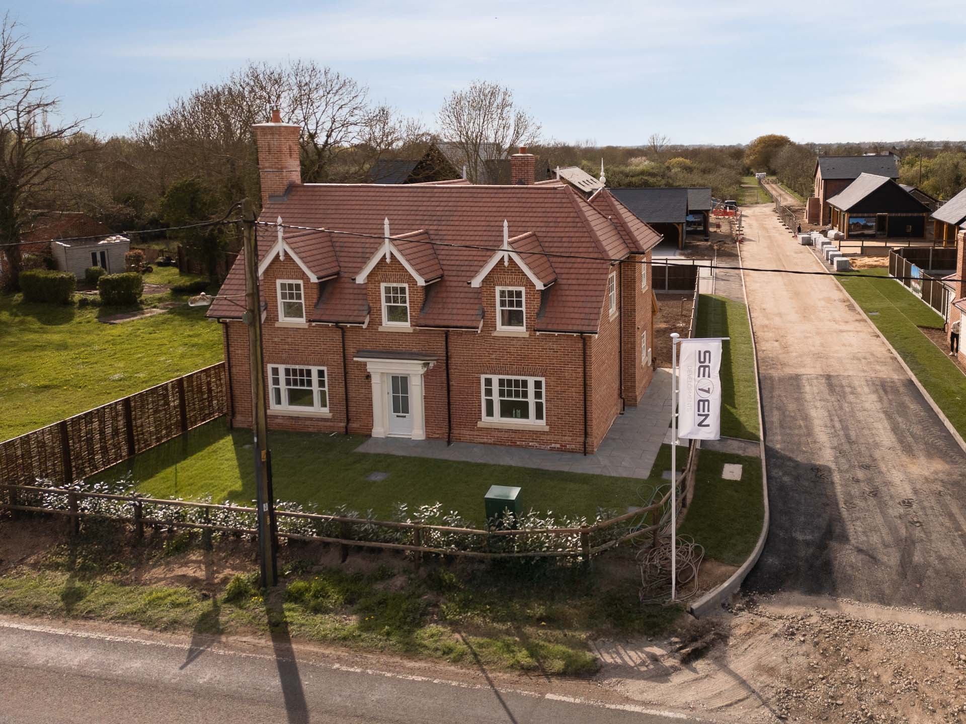 Aerial view of a brick home at The Nest, Abberton, showing the uPVC vertical sliding windows across the front elevation