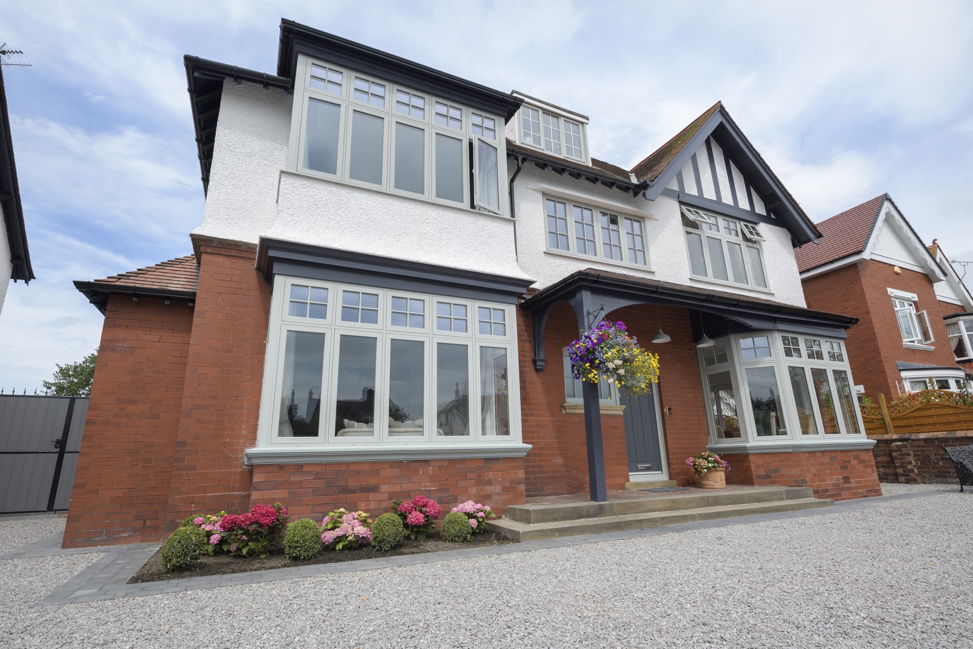 A rendered and brick house fitted throughout with Deceuninck Heritage Flush casement windows in a stone colourway