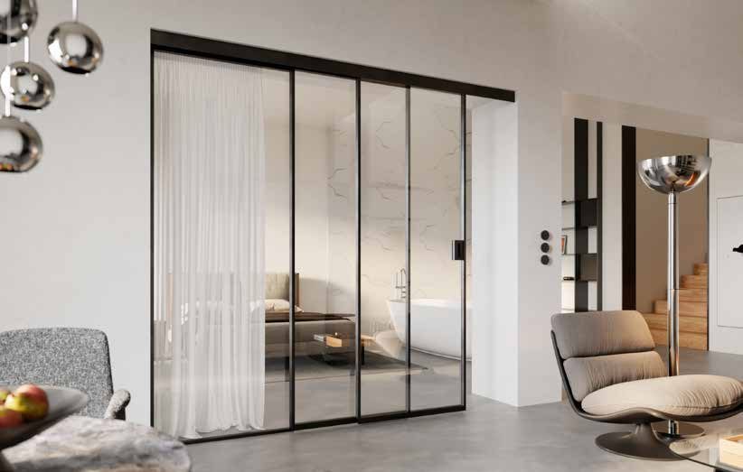 Wide black steel sliding doors with clear glass between a living room and a dining area